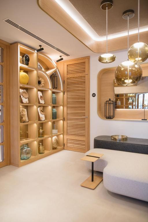 a living room with wooden shelves and a couch at MYR Puerta Serranos in Valencia