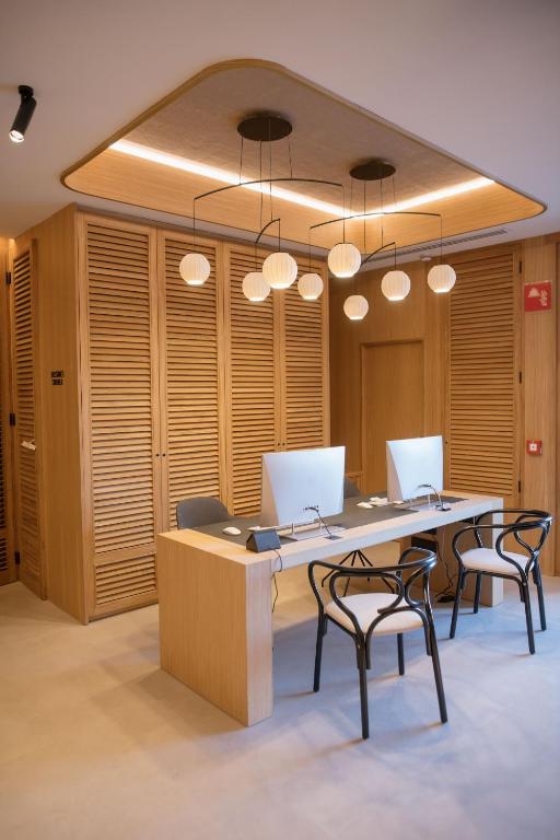 an office with a large table with chairs and lights at MYR Puerta Serranos in Valencia