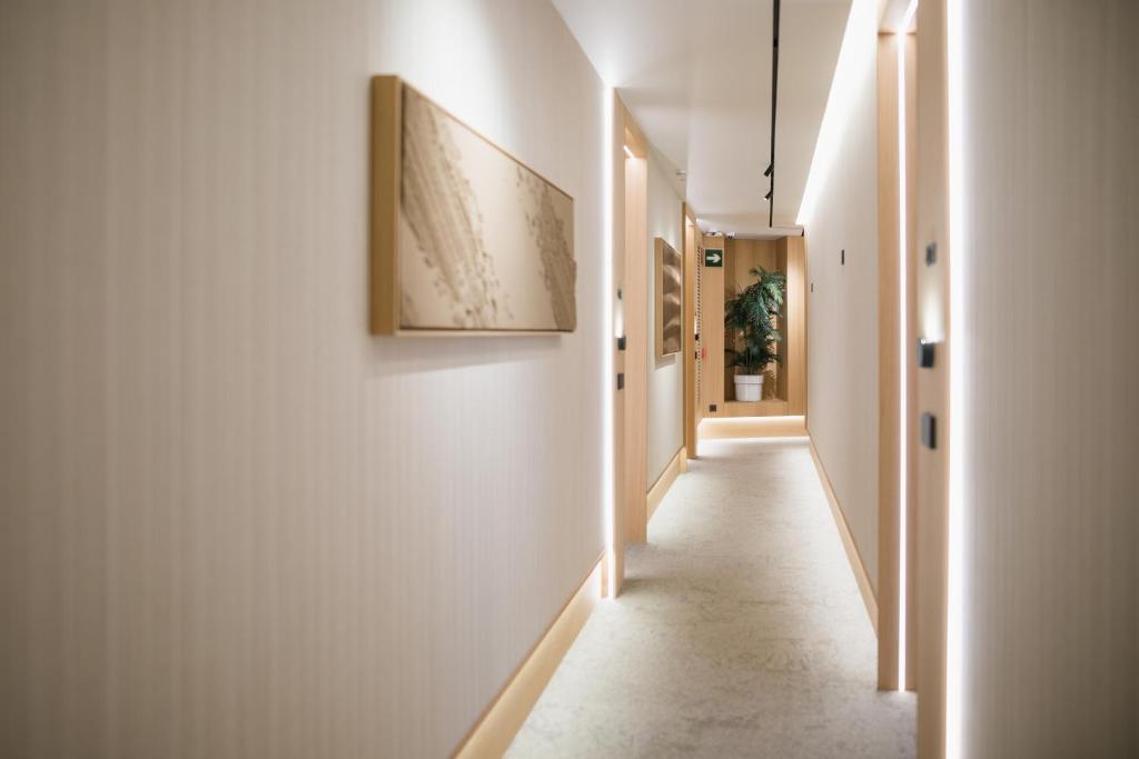 a hallway with white walls and a picture on the wall at MYR Puerta Serranos in Valencia
