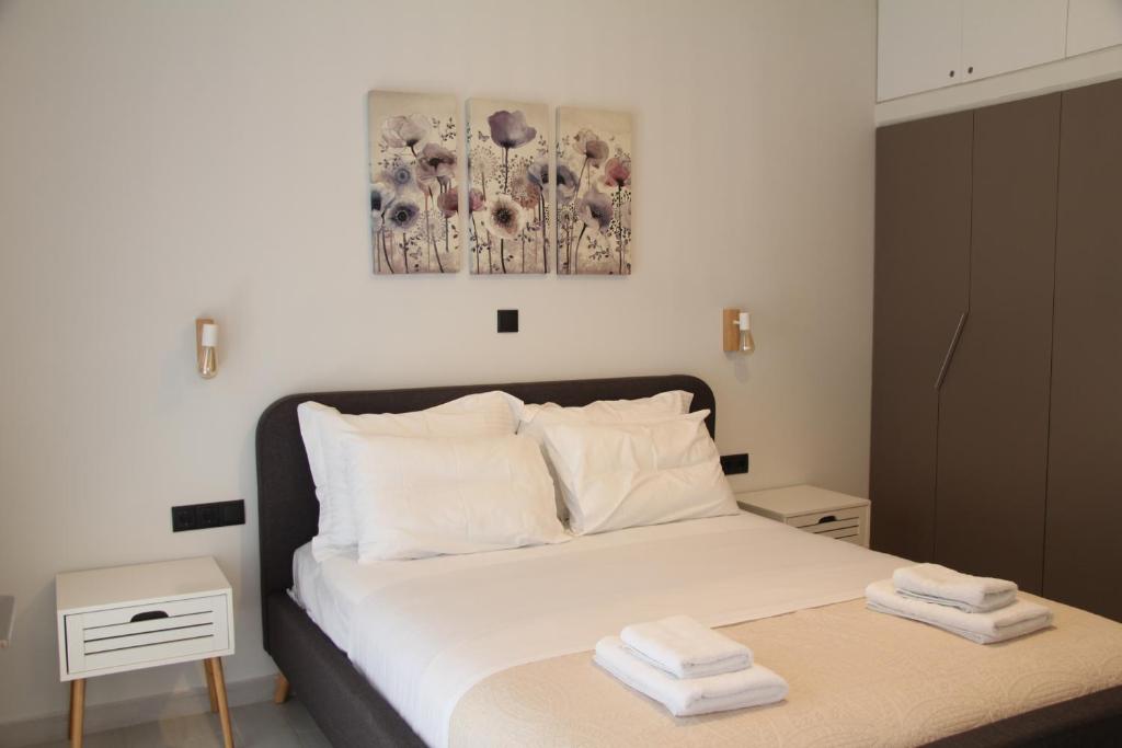 1 dormitorio con 1 cama con 2 toallas en Polyxenia’s Πλησίον Υγεία - Μητέρα - Ιασώ - ΟΑΚΑ, en Atenas
