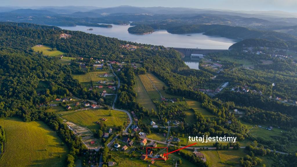 an aerial view of a village in the middle of a forest at Domki Noclegowe 693-664-683 in Solina