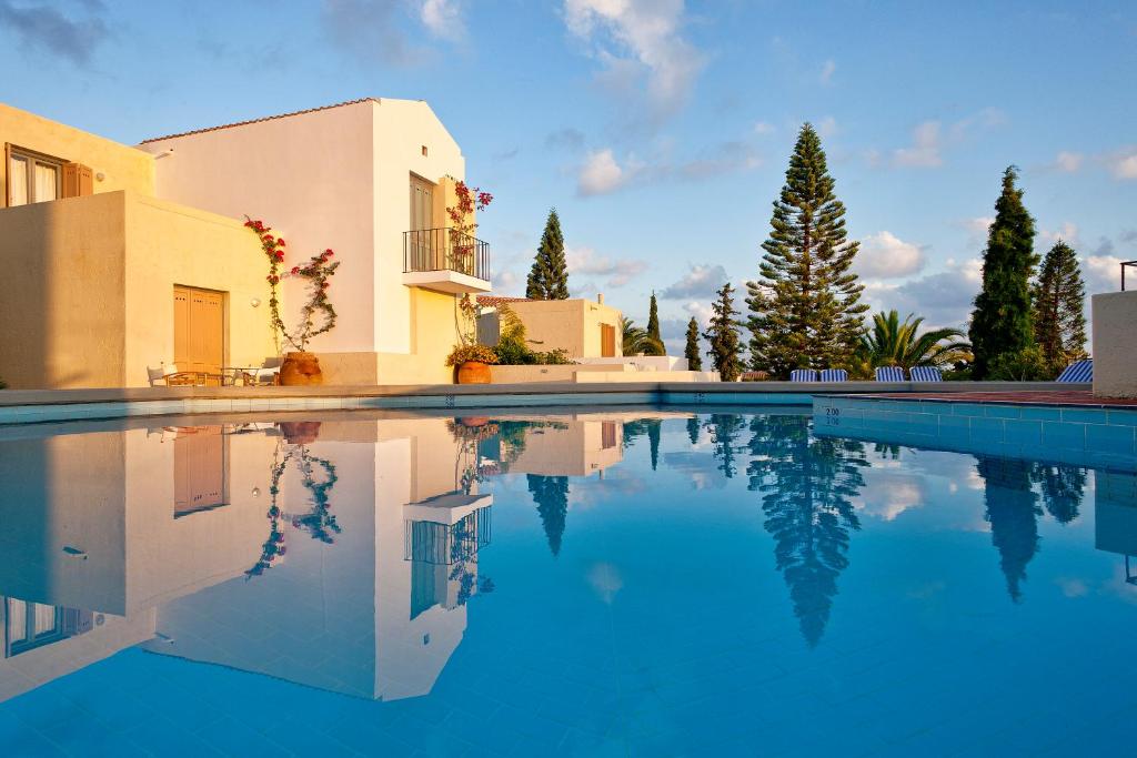 a swimming pool in front of a villa at Galaxy Villas in Hersonissos