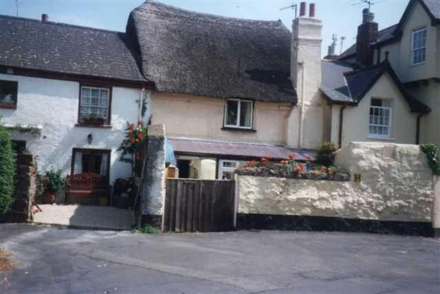 a white house with a gate and a fence at Dolphin Cottage 50m from Shaldon Beach! in Shaldon