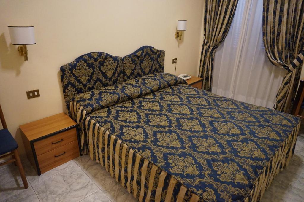 Postel nebo postele na pokoji v ubytování Hotel Mariano