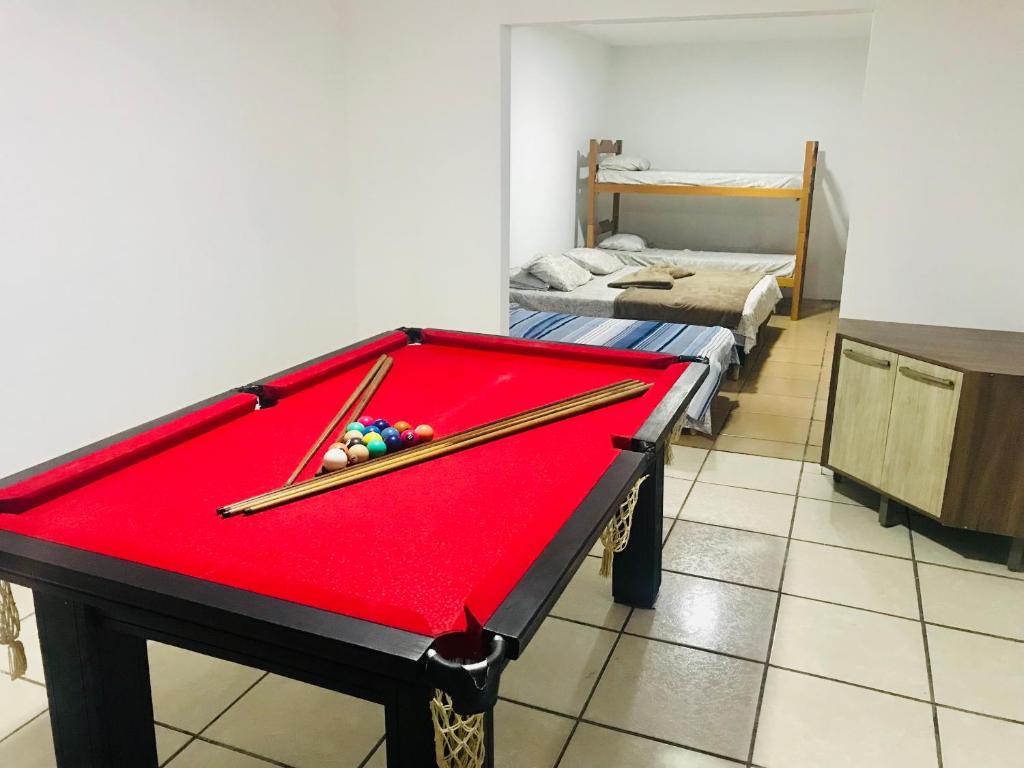a pool table with two cuesticks on top of it at TuRiStAnDo eM fLoRiPa in Florianópolis