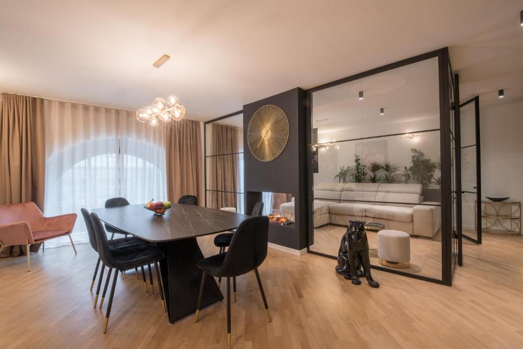 a dining room with a table and a living room at Brera Premium Apartment near Duomo Wifi in Milan
