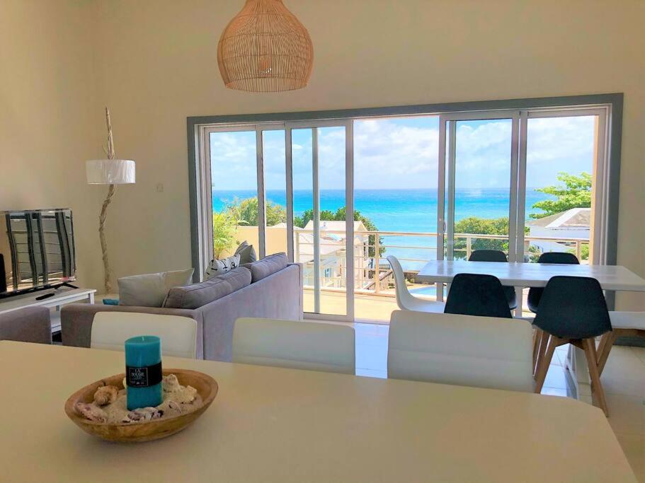a living room with a view of the ocean at Hibiscus Penthouse vue mer 2 chambres in Trou aux Biches