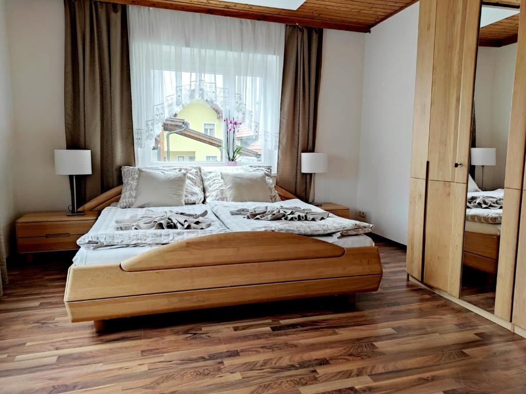 a bedroom with a large bed with a large window at Sigi Apartment in Barnbach