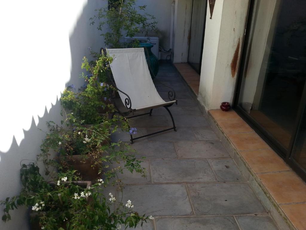 a chair sitting on a patio next to a building at Les Chambres de l'Abbaye in Marseille