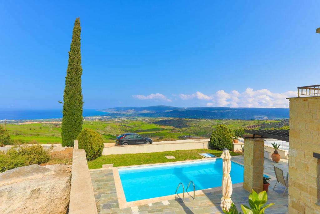 a villa with a swimming pool and a view of the ocean at Villa Styliani in Droushia