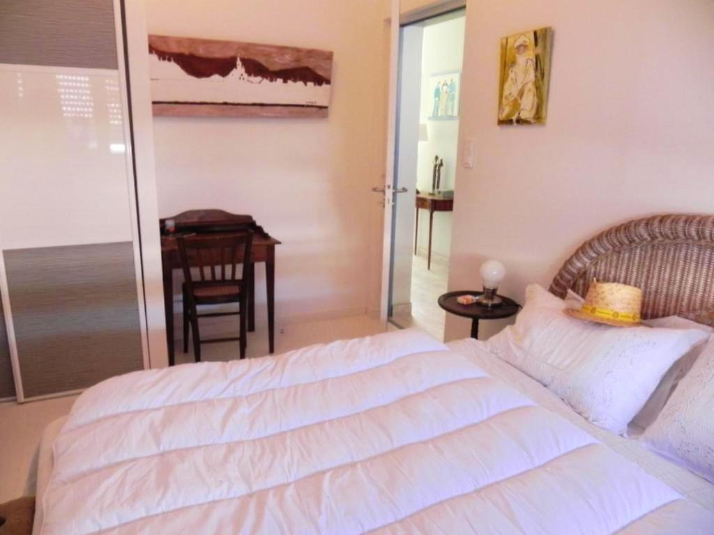 a bedroom with a large white bed and a table at Appartement de 3 chambres a Les Sables d&#39;Olonne a 800 m de la plage avec wifi in Les Sables-d&#39;Olonne
