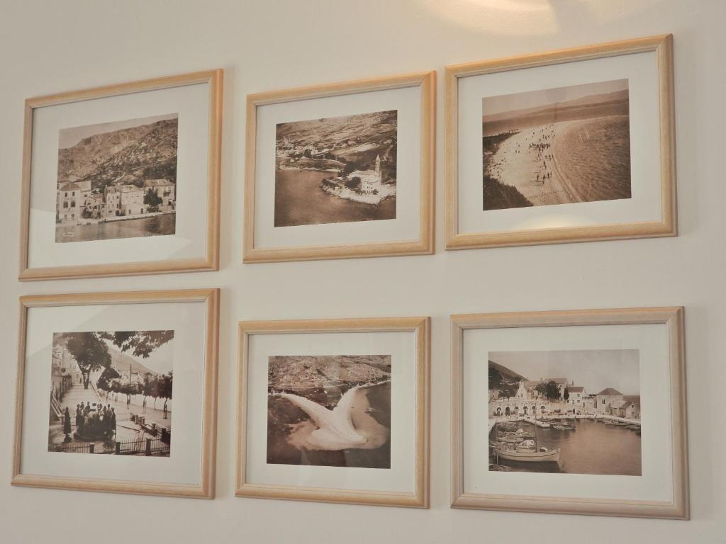 a group of framed pictures on a wall at Apartmani Robert in Bol