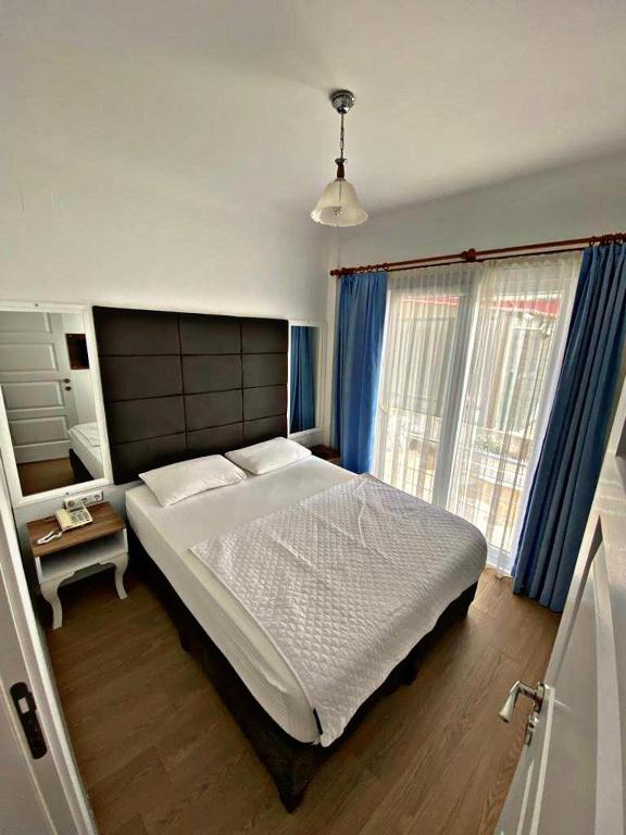 Postel nebo postele na pokoji v ubytování Lotus Otel