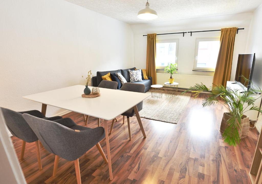 a living room with a white table and chairs at Koje Vier I mit Parkplatz, zentral und gemütlich in Bremerhaven