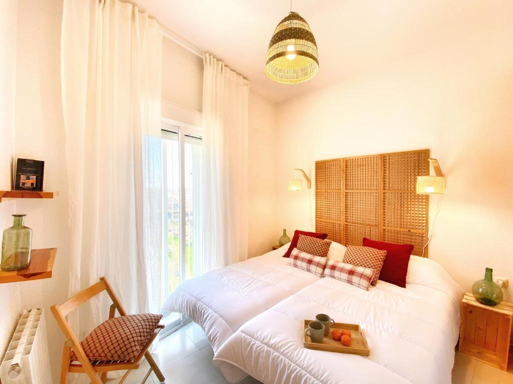 a bedroom with a bed and a large window at AQUI Brioca in Fuentes de la Alcarria