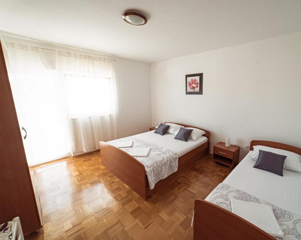 Postel nebo postele na pokoji v ubytování Apartments M&S