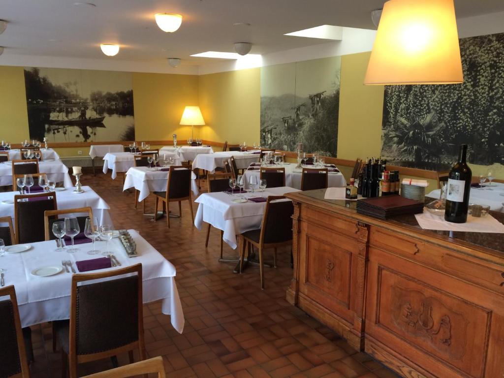 a dining room with white tables and chairs at Albergo della Posta in Astano