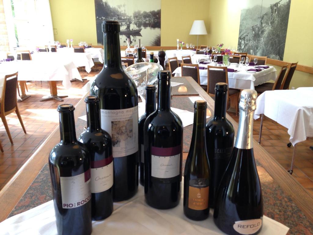 a group of wine bottles sitting on a table at Albergo della Posta in Astano