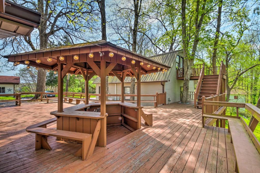 a wooden deck with a gazebo and benches at Stunning 2-Building Rental - Walk to Marina! in Celina