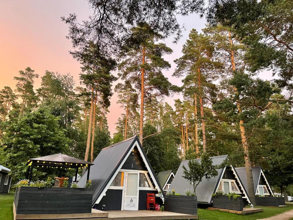 a row of tiny houses in a park at Camping Milk in Usmenieki
