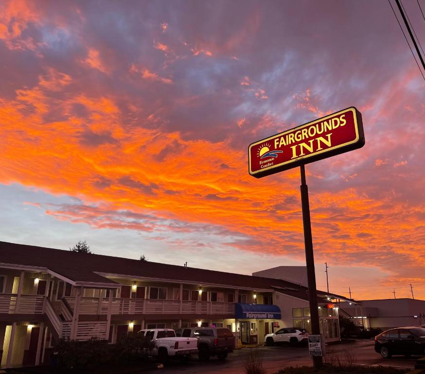 a sign in front of a building with a sunset at Fairground Inn in Monroe
