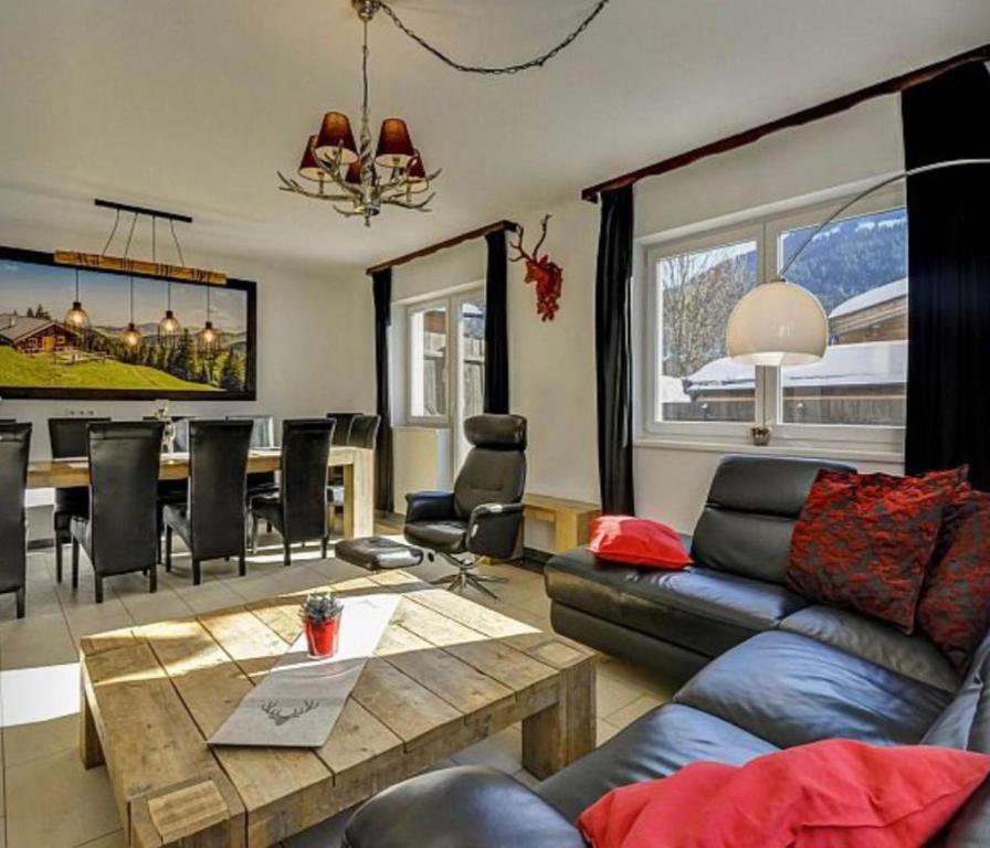 a living room with a couch and a table at Residenz im Dorf - Brixen im Thale in Brixen im Thale