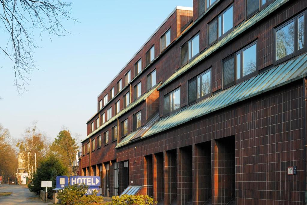 a red brick building with a hotel sign on it at Hotel Grunewald in Berlin
