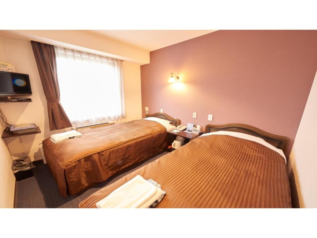 Ένα ή περισσότερα κρεβάτια σε δωμάτιο στο Famy Inn Makuhari - Vacation STAY 16036v