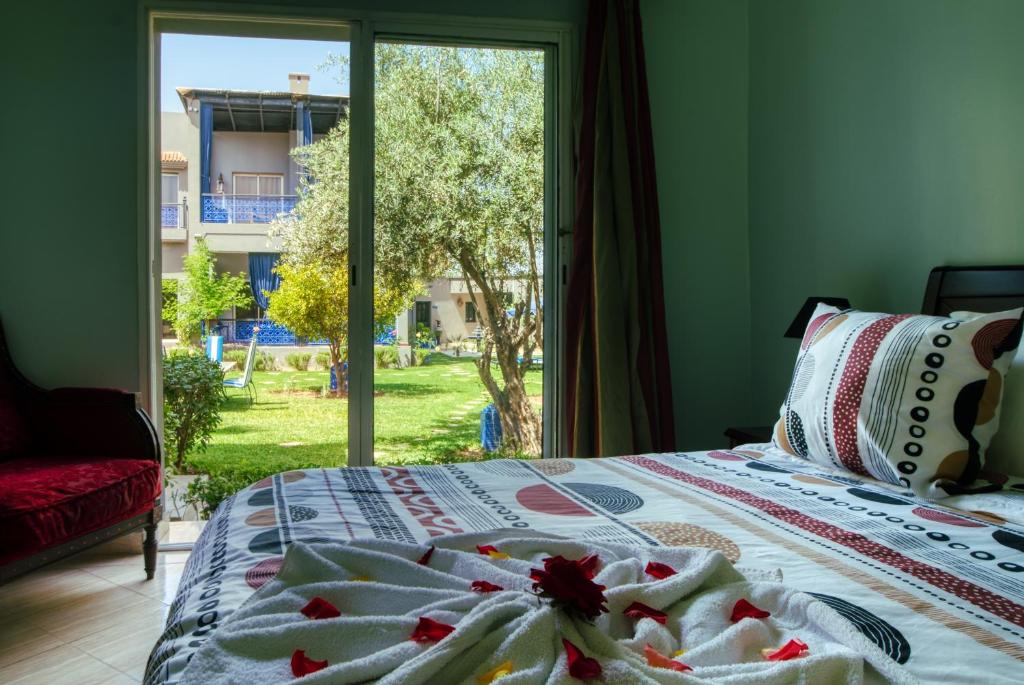 Postel nebo postele na pokoji v ubytování Villas 95 Appart'Hôtel