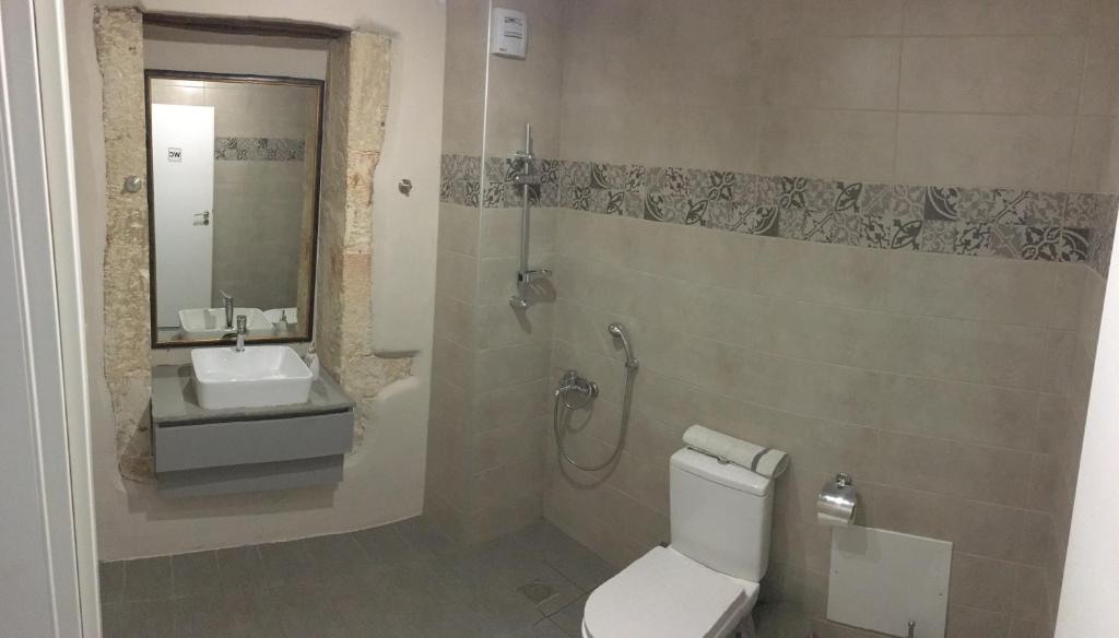 a bathroom with a toilet and a sink and a shower at Casa Mersini in Chania