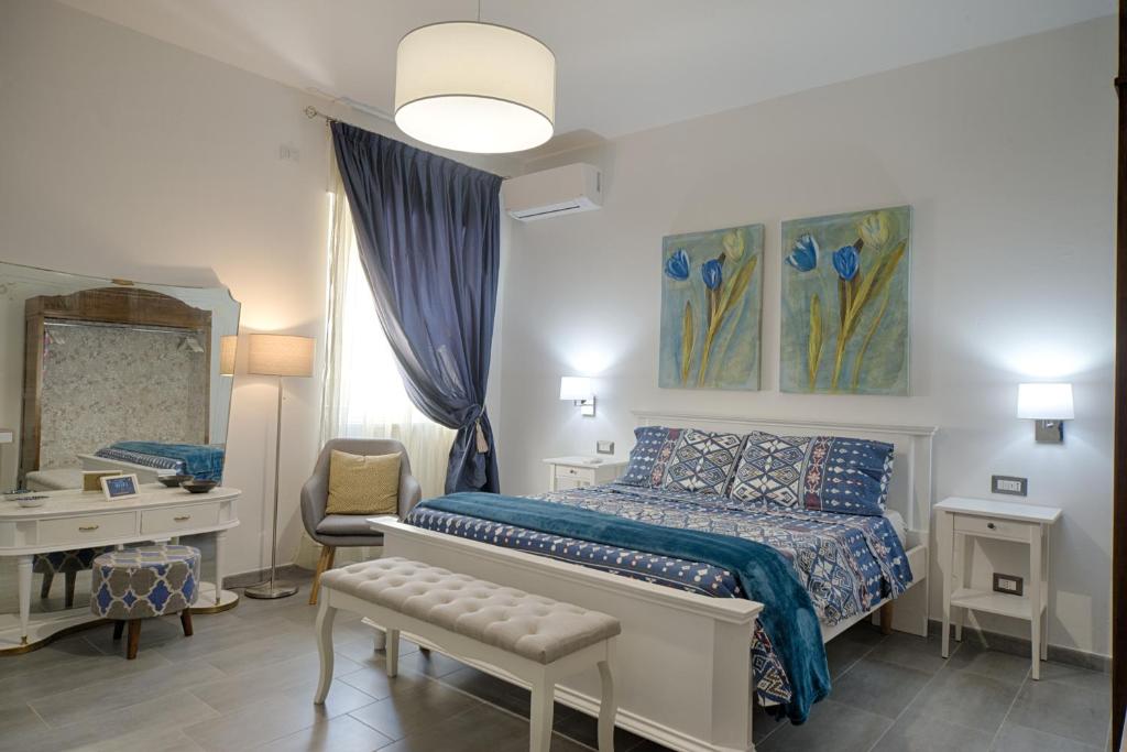 a bedroom with a bed and a desk and a mirror at Cozy guest house Downtown in Olbia