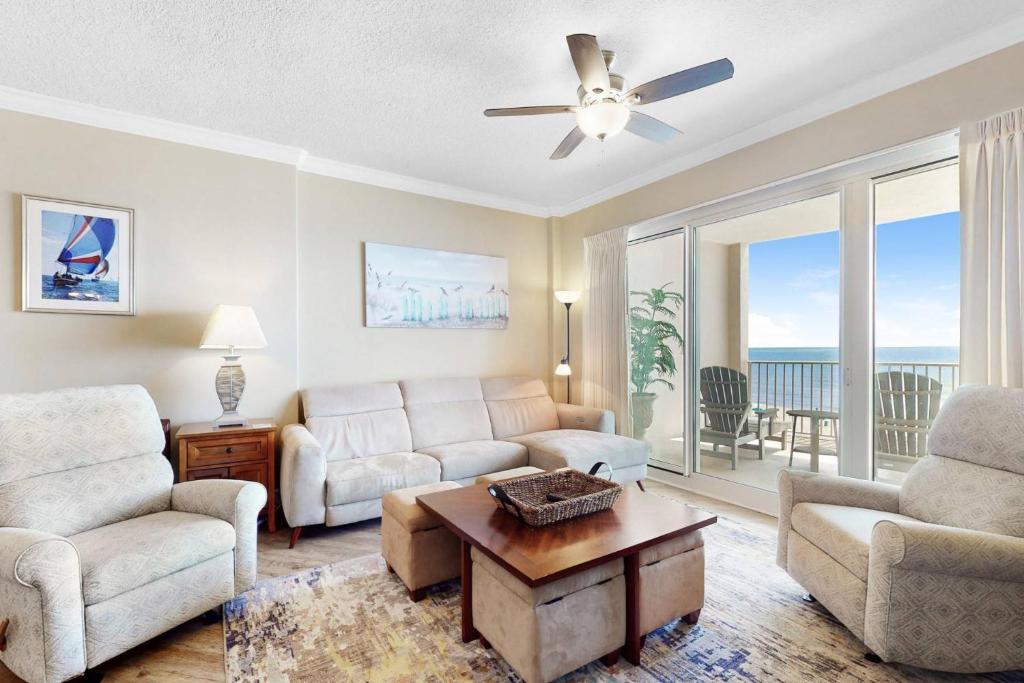 a living room with a couch and a table at Regency Isle 411 in Orange Beach