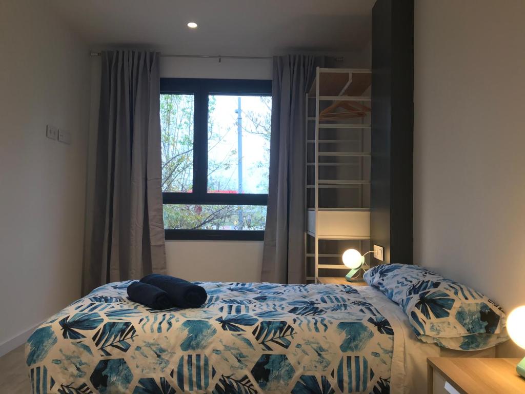 A bed or beds in a room at Llull Home