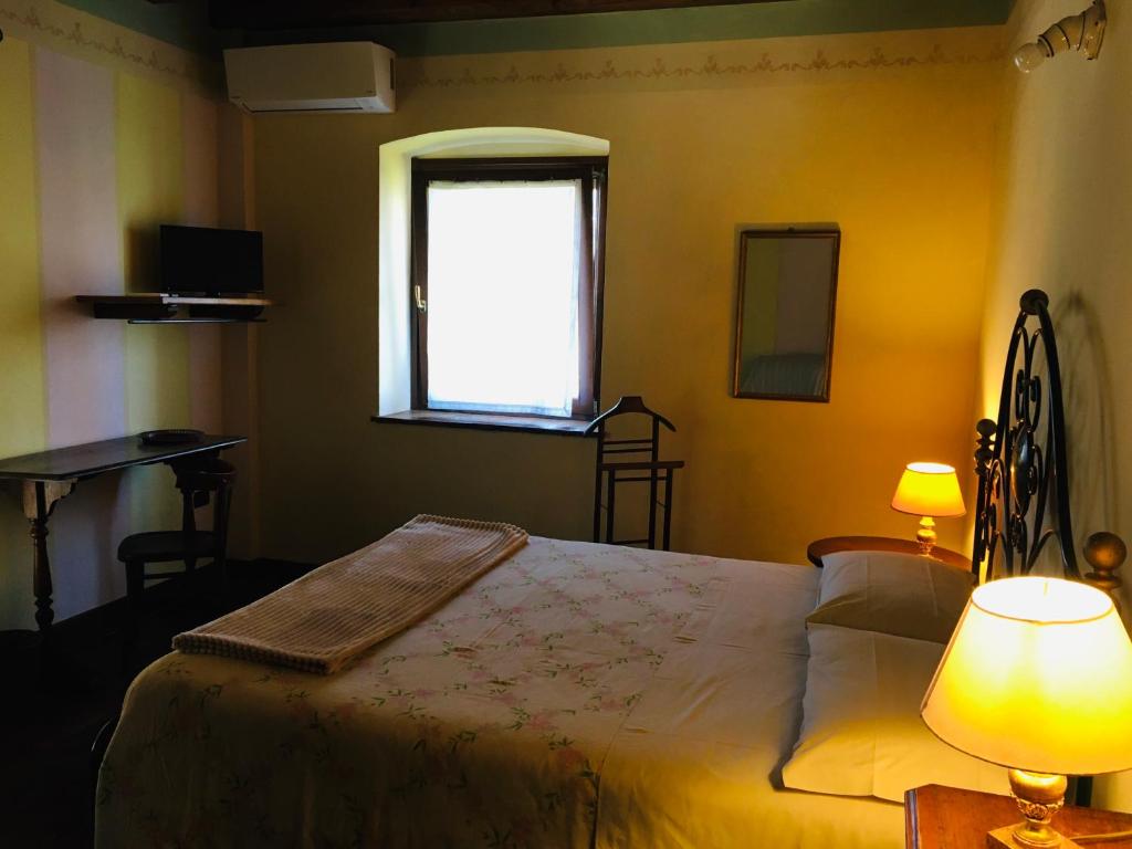 Postel nebo postele na pokoji v ubytování B&B Ai Tre Confini