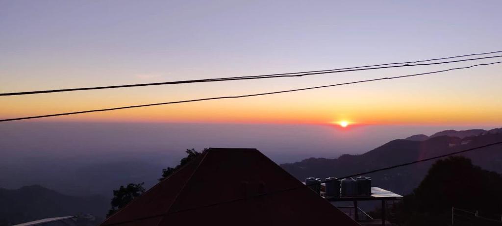 a view of the sunset from a roof at Hotel Valley Vista in Mussoorie