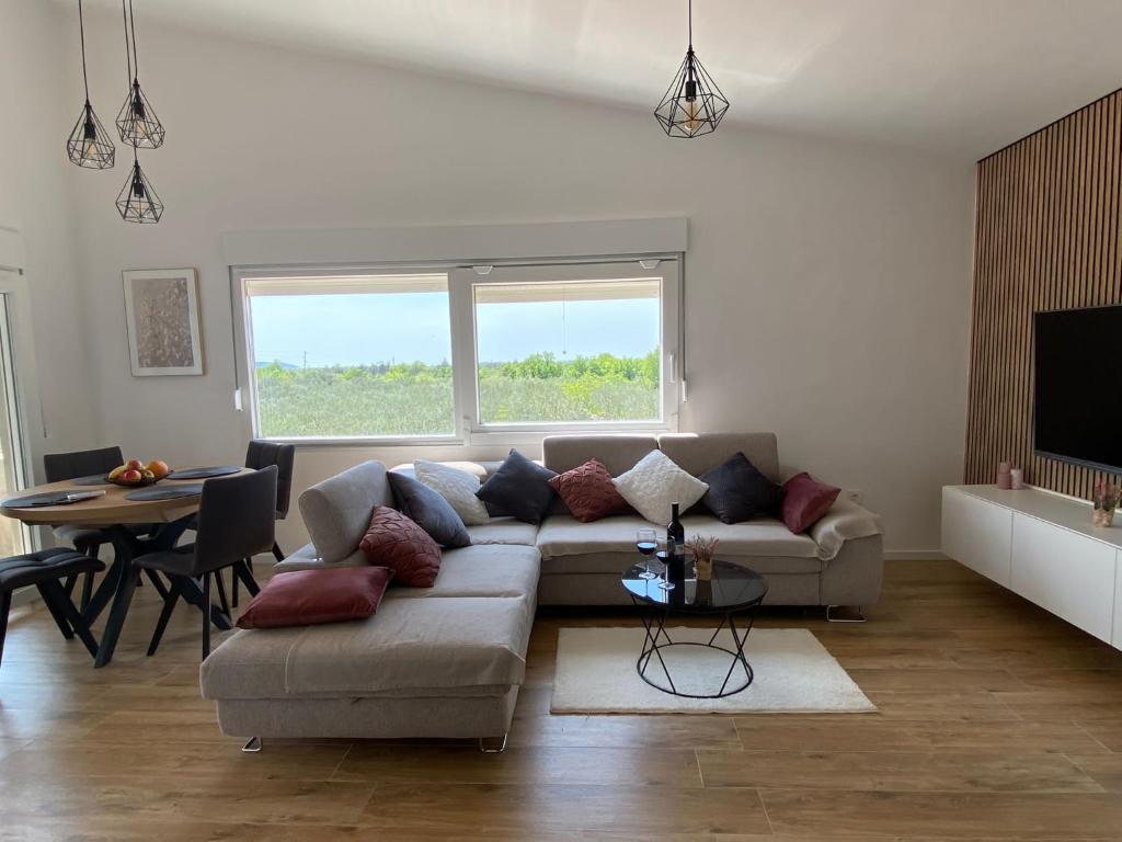 a living room with a couch and a table at Country House Peace in Drinovci