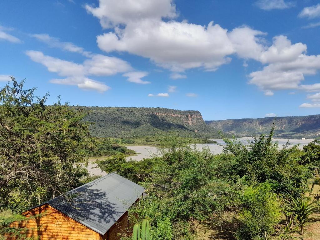 a view of a river and mountains with a house at Entendeni Lodge SelfCatering in Inanda