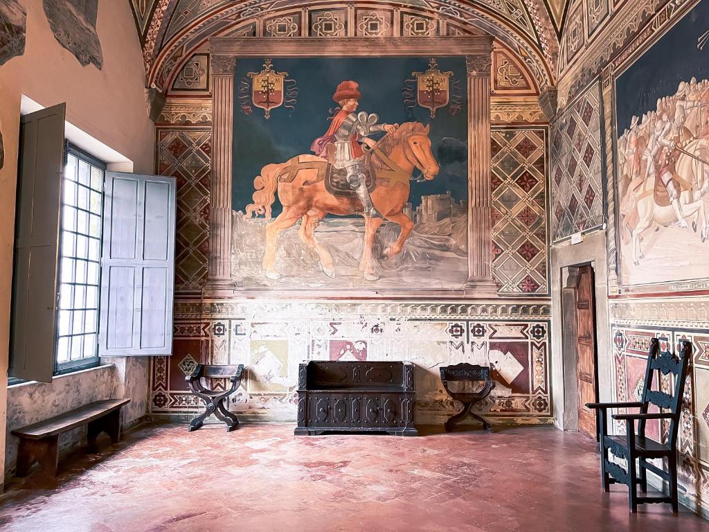 a living room with a painting of a horse on the wall at Castello di Fosdinovo in Fosdinovo
