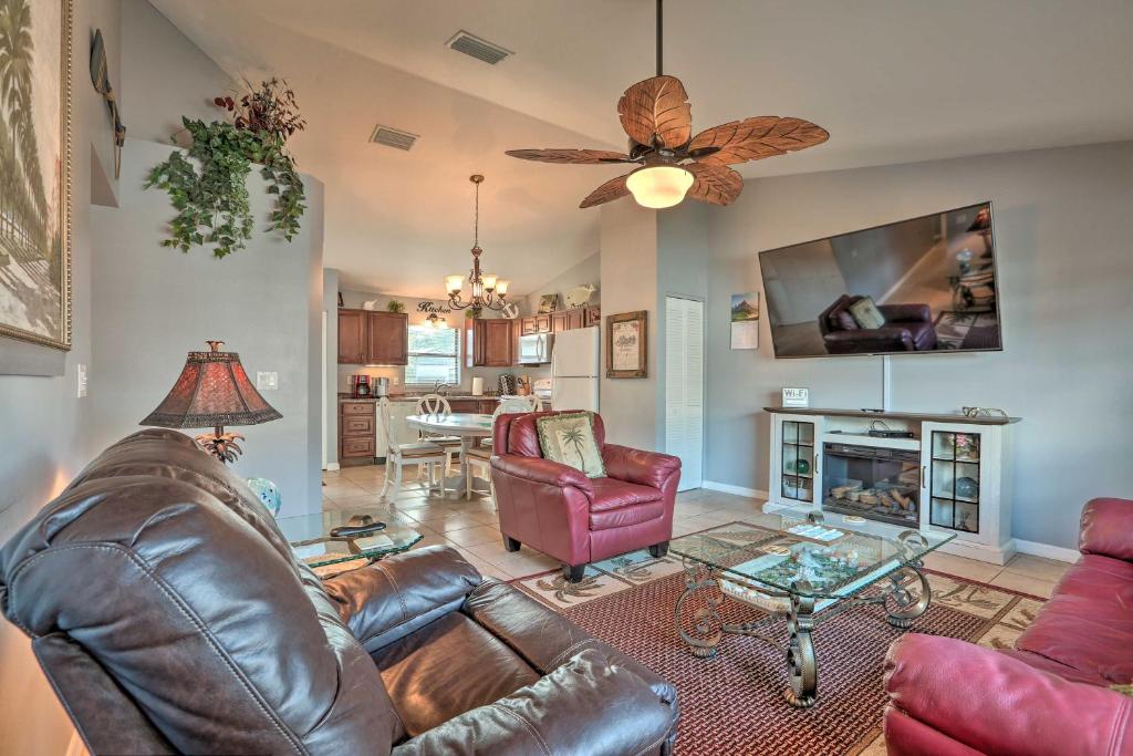 a living room with a leather couch and a fireplace at Condo with Screened-in Porch, 1 Mi to Sebring Golf! in Sebring