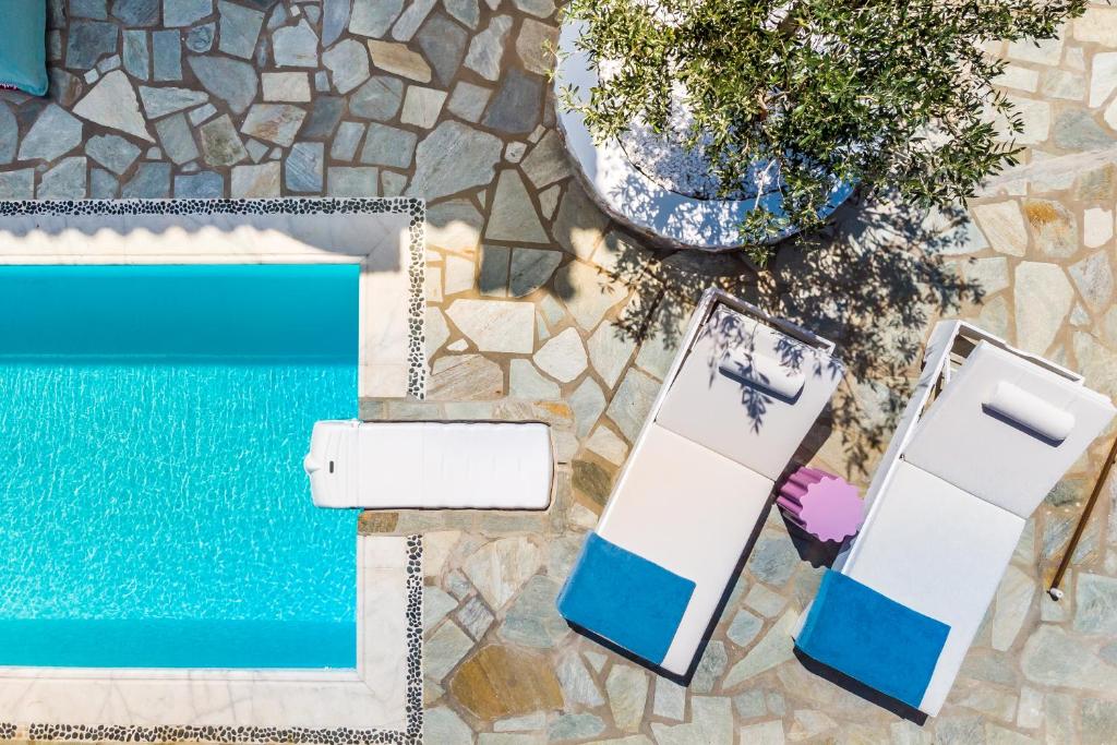 a cell phone next to a swimming pool at Villa Mariel Skopelos in Skopelos Town