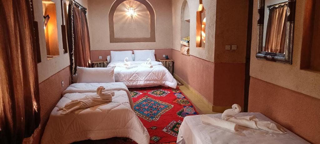 a room with two beds with babies laying on them at Dar Mezyana Dades in Aït Idaïr