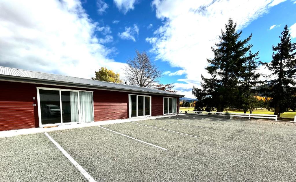 a parking lot in front of a red building at Lakeside Getaway in Otematata-2 bedroom unit - B3 in Otematata