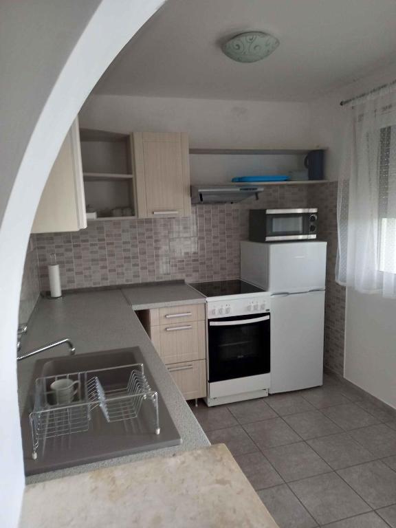 kuchnia ze zlewem i kuchenką górny piekarnik w obiekcie Holiday home in Balatongyörök 42694 w mieście Balatongyörök