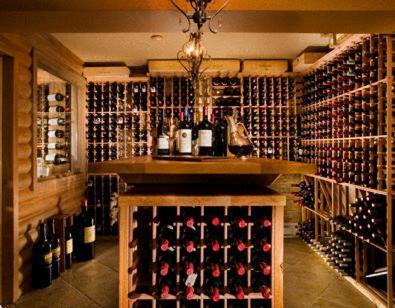 a wine cellar with a bunch of wine bottles at Auberge du Lac Morency in Saint-Hippolyte