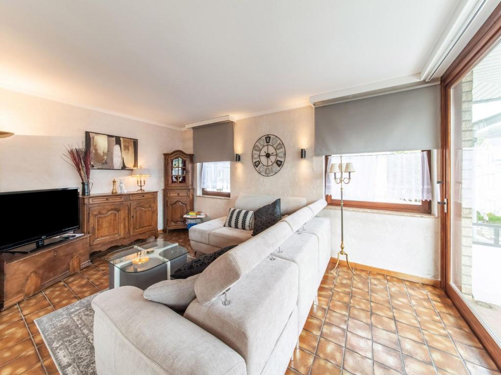 a living room with a couch and a tv at The Inseparable beautiful apartment for 7 adults in Malmedy in Malmedy