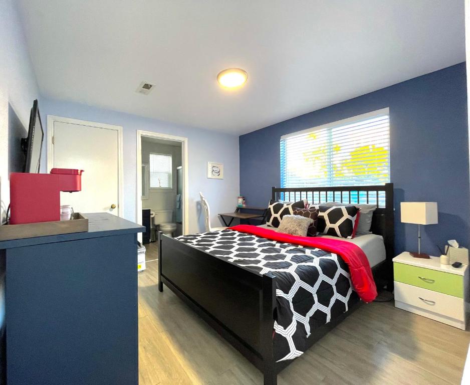 a bedroom with a black and white bed and blue walls at Golden Gate Park Suite in San Francisco