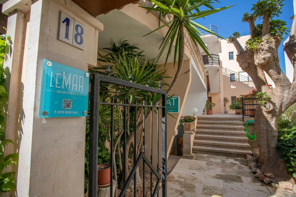 a gate to a house with a sign on it at Apartamentos Lemar in Colonia Sant Jordi