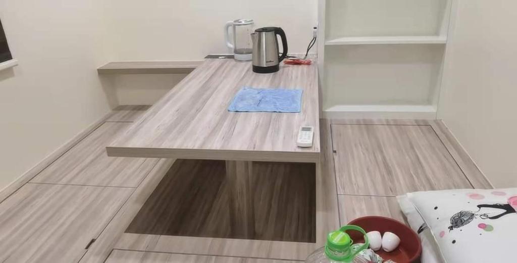 a table in a kitchen with a coffee maker on it at 米米民宿 in Kluang