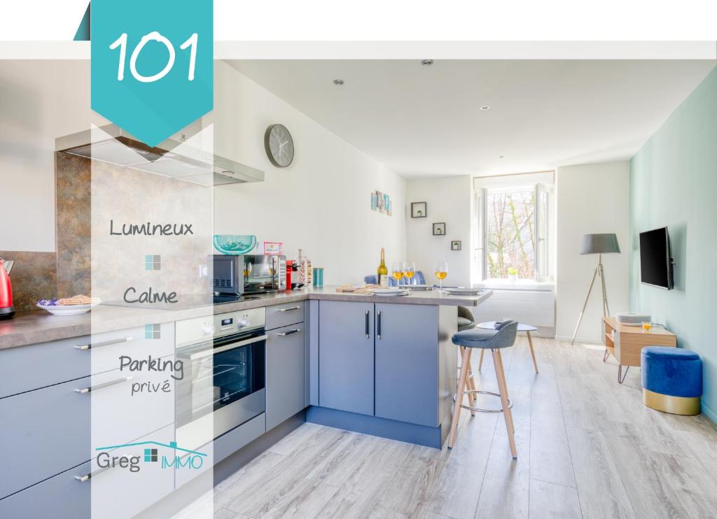 a kitchen with blue and white cabinets and a table at Le 101-GregIMMO-Appart'Hôtel in Audincourt