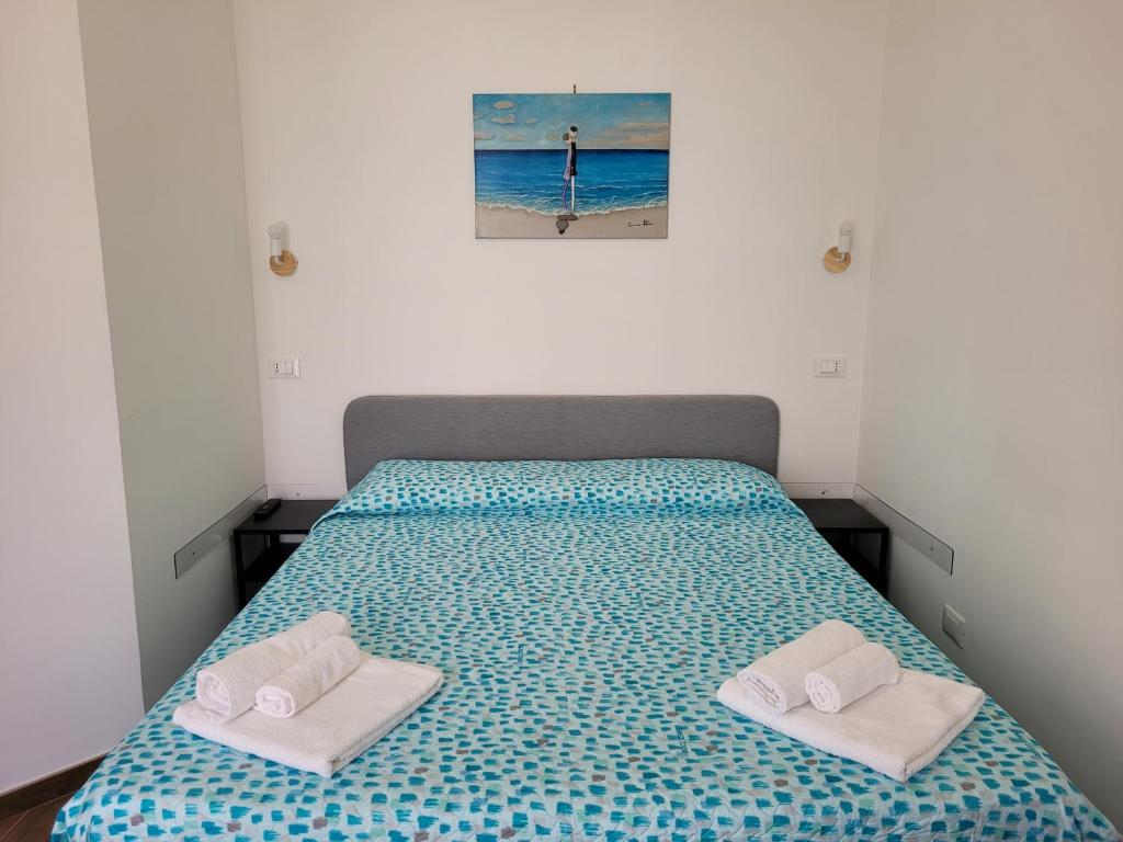 una camera da letto con un letto e due asciugamani di Casa "Paolo e Francesca" Monolocali a Scilla